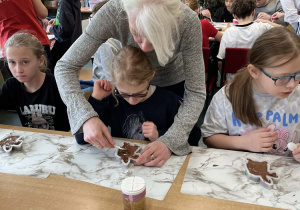 Pani pomagająca dzieciom podczas warsztatów.